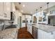 A modern kitchen featuring a large island with granite countertop, stainless steel appliances, and hardwood floors at 4220 Thames Cir, Fort Mill, SC 29715