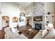Spacious living room with a stone fireplace, built-in shelving, and hardwood floors at 4220 Thames Cir, Fort Mill, SC 29715