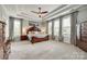 Expansive main bedroom with tray ceiling, plush carpet, and ample natural light, creating a serene retreat at 4220 Thames Cir, Fort Mill, SC 29715