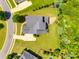 Expansive home with a well-maintained lawn, mature landscaping and outdoor seating area at 4220 Thames Cir, Fort Mill, SC 29715