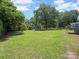Spacious backyard featuring mature trees, green grass, and a storage shed at 427 E 12Th Ave, Gastonia, NC 28054