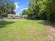 Fenced backyard with lush lawn, brick fire pit and distant view of the home at 427 E 12Th Ave, Gastonia, NC 28054