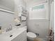 Cozy bathroom featuring a decorative towel rack, vanity, and window providing natural light at 427 E 12Th Ave, Gastonia, NC 28054