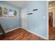 Light blue bedroom provides natural light and storage with mounted shelving at 427 E 12Th Ave, Gastonia, NC 28054