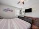 The bright bedroom includes a TV, dresser, ceiling fan, and a view of the outdoors at 427 E 12Th Ave, Gastonia, NC 28054