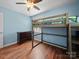 This room is equipped with wood floors and features a gray bunkbed at 427 E 12Th Ave, Gastonia, NC 28054