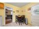 Cozy eat-in kitchen features warm yellow walls and modern stainless steel trash receptacle at 427 E 12Th Ave, Gastonia, NC 28054