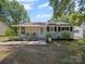 Charming single-story home with a covered porch, landscaped yard, and mature trees at 427 E 12Th Ave, Gastonia, NC 28054