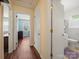 Bright hallway leads to bedroom and bathroom, featuring wood-look flooring and fresh paint at 427 E 12Th Ave, Gastonia, NC 28054