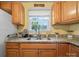 Bright kitchen area with wood cabinets, granite countertops, and modern fixtures at 427 E 12Th Ave, Gastonia, NC 28054