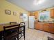 Eat-in kitchen with tile floor, dining table, and white appliances at 427 E 12Th Ave, Gastonia, NC 28054