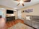 Open living room features wood floors, modern TV stand and access to front door at 427 E 12Th Ave, Gastonia, NC 28054