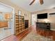 Inviting living room featuring hardwood floors, an entertainment center, and open access to the kitchen at 427 E 12Th Ave, Gastonia, NC 28054