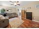 Comfortable living room featuring hardwood floors, a ceiling fan, and ample seating space at 427 E 12Th Ave, Gastonia, NC 28054