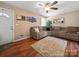 Cozy living room featuring new hardwood floors, natural light, and a large sofa at 427 E 12Th Ave, Gastonia, NC 28054