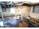 Unfinished basement featuring exposed rafters, concrete floor, and painted walls at 506 Linwood Rd, Gastonia, NC 28052