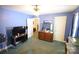 This bedroom features blue walls, a wood dresser, and a ceiling fan with light at 506 Linwood Rd, Gastonia, NC 28052