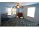Simple blue bedroom with a window, ceiling fan, and standard closet at 506 Linwood Rd, Gastonia, NC 28052
