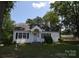 Quaint single-level home featuring dark shutters, neutral paint, and a classic roofline at 506 Linwood Rd, Gastonia, NC 28052