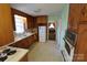 Classic kitchen with wood cabinetry, gas range, and view into an adjacent room at 506 Linwood Rd, Gastonia, NC 28052