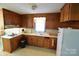Traditional kitchen with wood cabinets, white appliances, and a practical layout at 506 Linwood Rd, Gastonia, NC 28052