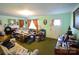 Bright living room showcasing green walls and carpet, a fireplace, and vintage decor at 506 Linwood Rd, Gastonia, NC 28052