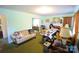 Spacious living room featuring vintage furniture, green walls and carpet, and lots of natural light at 506 Linwood Rd, Gastonia, NC 28052