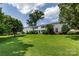 Inviting exterior of a well-maintained building with lush green lawn, mature trees and manicured landscaping at 528 Wakefield Dr # A, Charlotte, NC 28209