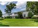 Charming exterior view of a well-maintained building with lush green lawn, mature trees, and inviting entrances at 528 Wakefield Dr # A, Charlotte, NC 28209