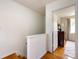 Upstairs hallway with hardwood floors, leading to a bedroom with natural light at 528 Wakefield Dr # A, Charlotte, NC 28209