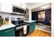 Stylish kitchen features modern appliances, dark green custom cabinetry, and open layout perfect for cooking and entertaining at 528 Wakefield Dr # A, Charlotte, NC 28209