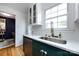 Bright kitchen features white cabinets, granite countertops, stainless steel appliances, and a sink beneath a bright window at 528 Wakefield Dr # A, Charlotte, NC 28209
