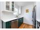 Clean white kitchen with open shelving and modern sink fixtures features stainless steel appliances and hardwood floors at 528 Wakefield Dr # A, Charlotte, NC 28209