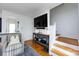 Bright living room featuring hardwood floors, modern furnishings, and convenient access to the staircase at 528 Wakefield Dr # A, Charlotte, NC 28209