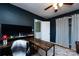 This office space features dark-blue walls, hardwood flooring and a modern desk with computer monitors at 528 Wakefield Dr # A, Charlotte, NC 28209