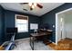 This office space features dark-blue walls, hardwood flooring, a white board and a modern desk with computer monitors at 528 Wakefield Dr # A, Charlotte, NC 28209