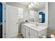 Bright bathroom with large vanity mirror, white cabinets, toilet and sink at 529 River Park Rd, Belmont, NC 28012
