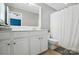 Bright bathroom with large vanity mirror, toilet and tiled shower with curtain at 529 River Park Rd, Belmont, NC 28012
