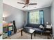 Bedroom boasts a ceiling fan, window with blue curtains, and a cozy blue sofa at 529 River Park Rd, Belmont, NC 28012
