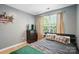 Bedroom featuring a gray color scheme, wood flooring, natural light, and a dark wood dresser at 529 River Park Rd, Belmont, NC 28012
