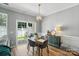 Bright dining room with modern light fixture and sliding glass doors to the backyard at 529 River Park Rd, Belmont, NC 28012