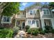 Attractive townhome featuring stone accents, front porch, and landscaped bushes at 529 River Park Rd, Belmont, NC 28012