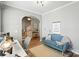Bright home office featuring a cozy couch, workspace, and arched doorway at 529 River Park Rd, Belmont, NC 28012