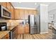 Well-equipped kitchen with stainless steel appliances, granite countertops, and wooden cabinets at 529 River Park Rd, Belmont, NC 28012
