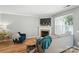 Well-lit living room featuring hardwood floors, a fireplace, and large windows offering plenty of natural light at 529 River Park Rd, Belmont, NC 28012