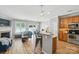 Open-concept living room featuring wood floors, fireplace, and a view of the kitchen with granite countertops at 529 River Park Rd, Belmont, NC 28012