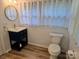 Bright bathroom features a navy vanity, gold fixtures, round mirror and natural light at 616 Laurel St, Albemarle, NC 28001
