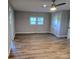 Spacious bedroom with hardwood floors, ample natural light, a ceiling fan, and a closet at 616 Laurel St, Albemarle, NC 28001