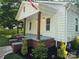 Charming home featuring a covered front porch with brick accents and well-manicured landscaping at 616 Laurel St, Albemarle, NC 28001