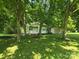 Charming home with mature trees in front yard, shed and grass lawn at 616 Laurel St, Albemarle, NC 28001